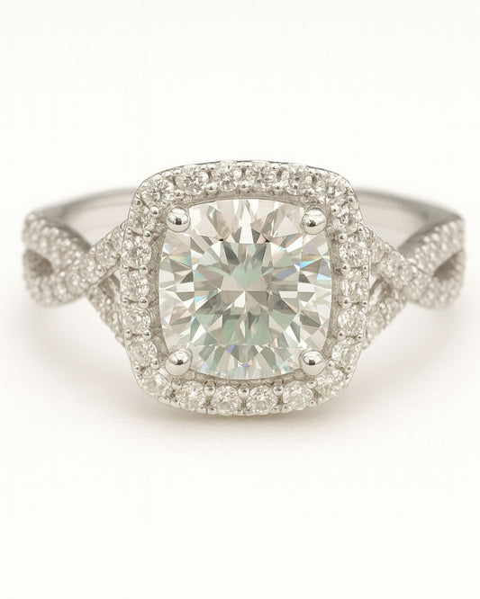 Diamond ring with a central gemstone and halo on a white background